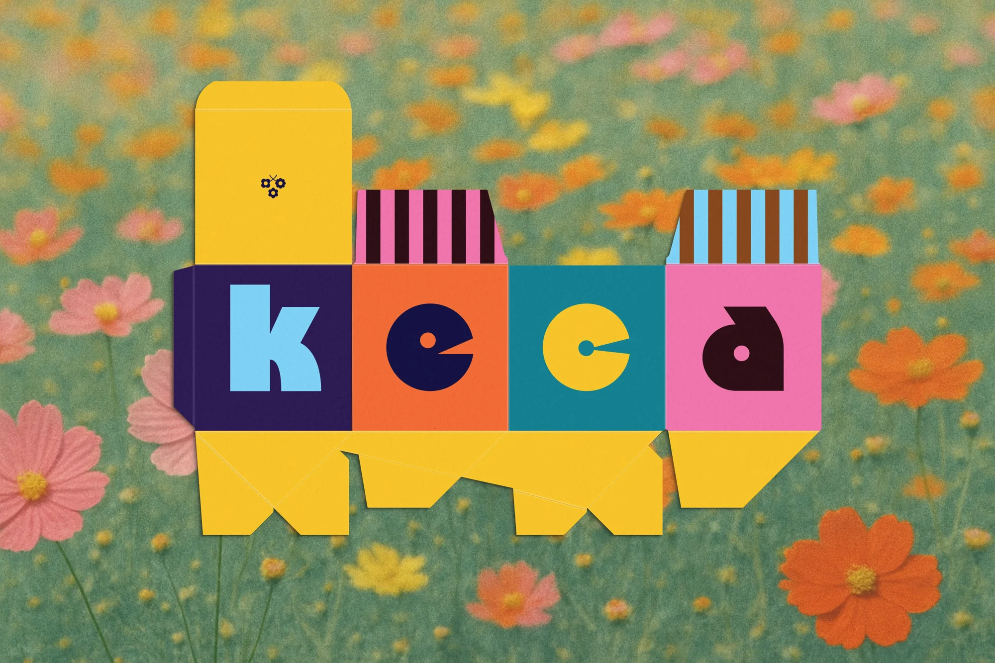 Graphic image of the word 'keca' formed from colorful block letters on a deconstructed box, set against a floral meadow background.