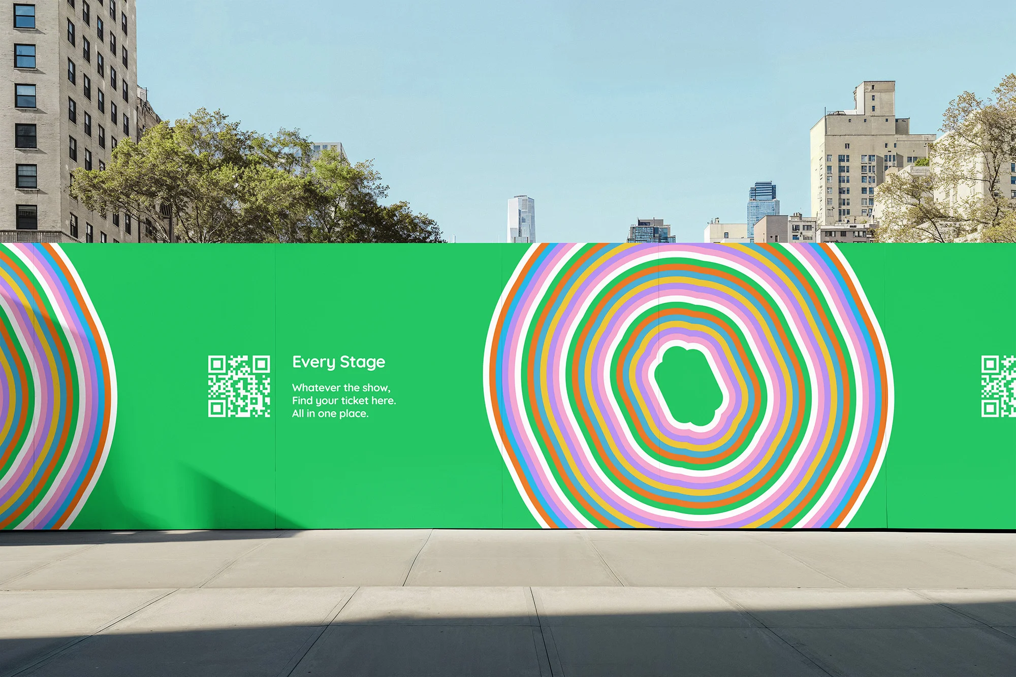 Outdoor advertisement featuring a concentric circle design in white, purple, orange and green, with text and a QR code on a bright green background.
