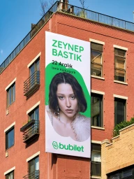 Large vertical outdoor billboard poster for Bubilet featuring a concert advertisement mounted on the exterior of a red brick building.