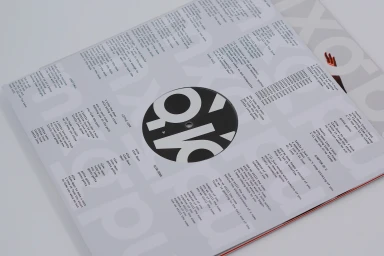 Close-up of a printed vinyl record inner sleeve with typographic lyrics and a bold black center label by MXGPU.