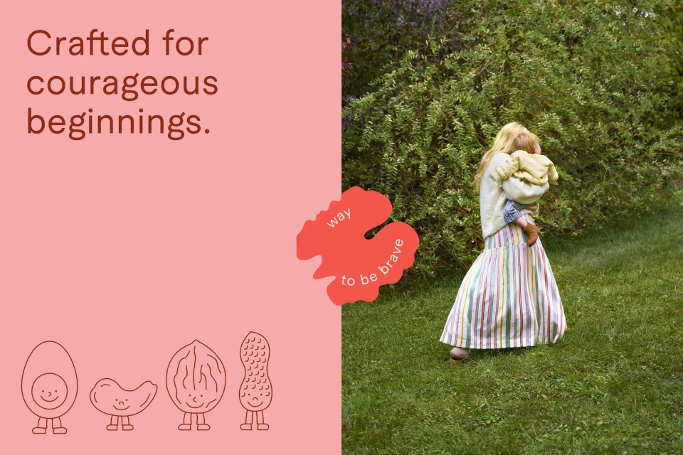 Woman in striped skirt holds toddler outside on grass near green leafy bushes; text on salmon-colored background to the left.