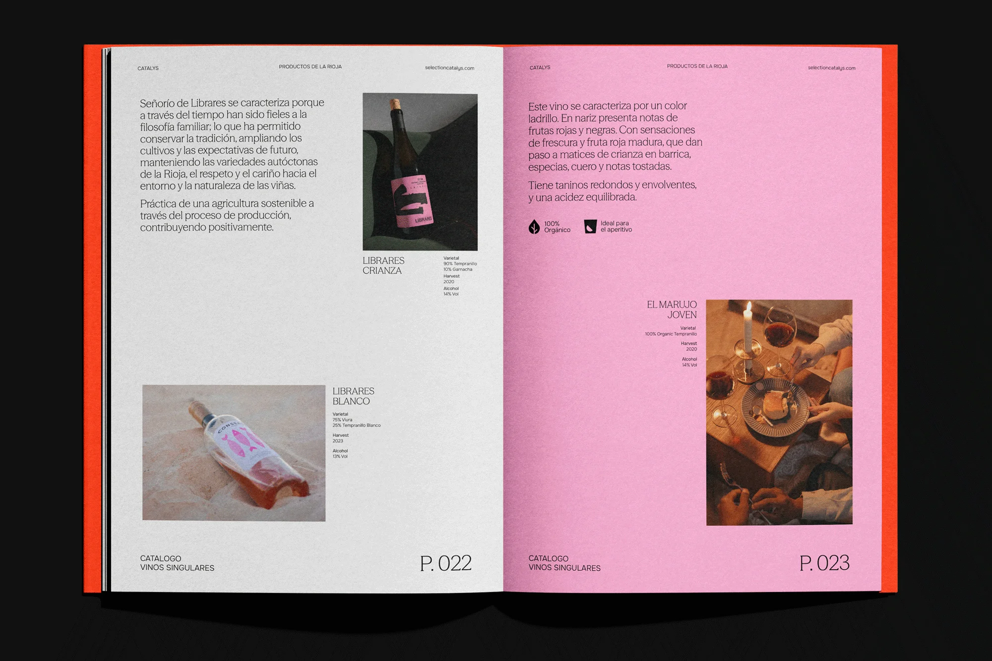 Open magazine spread features wine product catalog, close-up shot of bottles, glasses, and text on white and pink pages with modern layout.