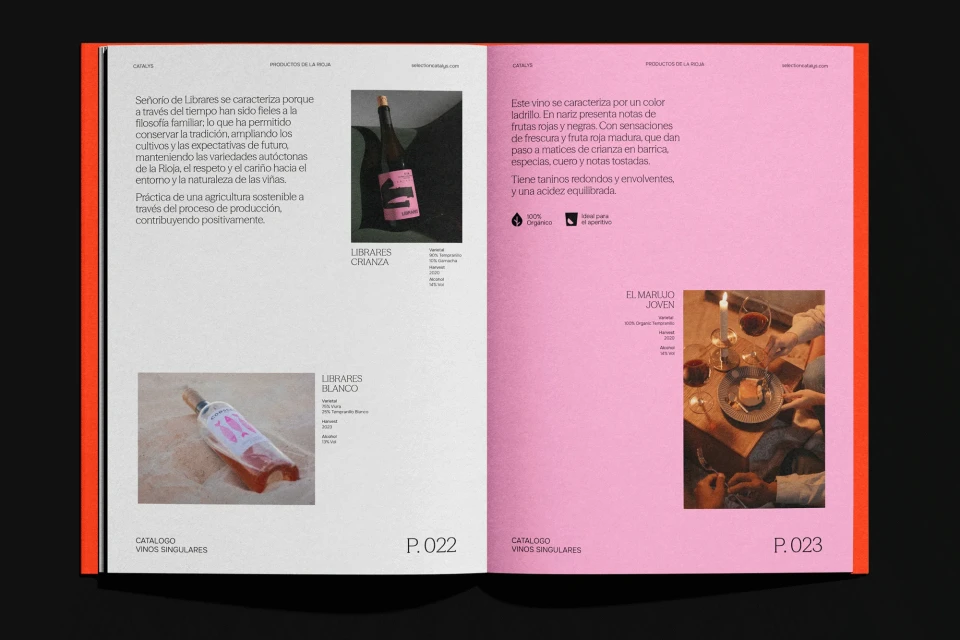 Open magazine spread features wine product catalog, close-up shot of bottles, glasses, and text on white and pink pages with modern layout.