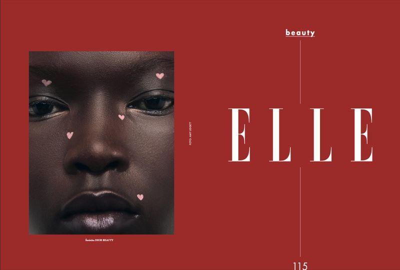 Close-up beauty shot of a Black model with heart accents on her face, next to the word ELLE in a vertical fashion editorial on a red background.