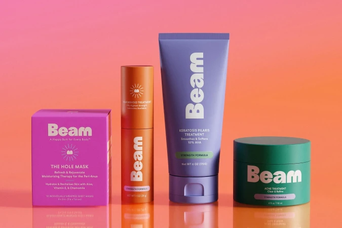 Four Beam brand skincare products including a face mask, acne treatment, and keratosis pilaris treatment arranged against an orange background.
