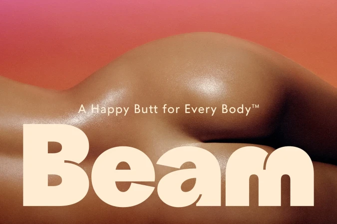 Woman's back and buttocks against a gradient peach and pink background. 'Beam' in cream text is displayed in the foreground.