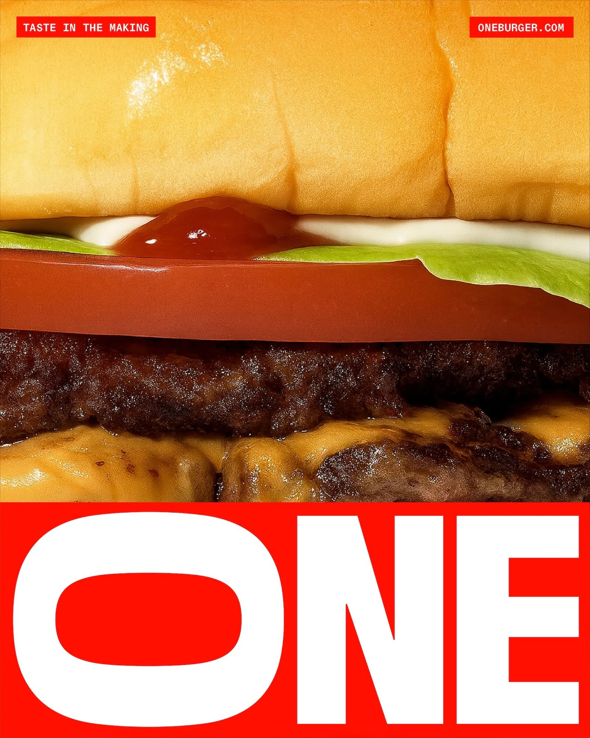 Close-up shot of a hamburger showcasing the layers of the bun, tomato, lettuce, patty, and cheese, with the word 'ONE' in red.