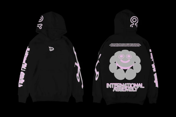 Black hooded sweatshirt featuring graphic designs of abstract symbols, text, and a cartoon-style flower figure, product photography.