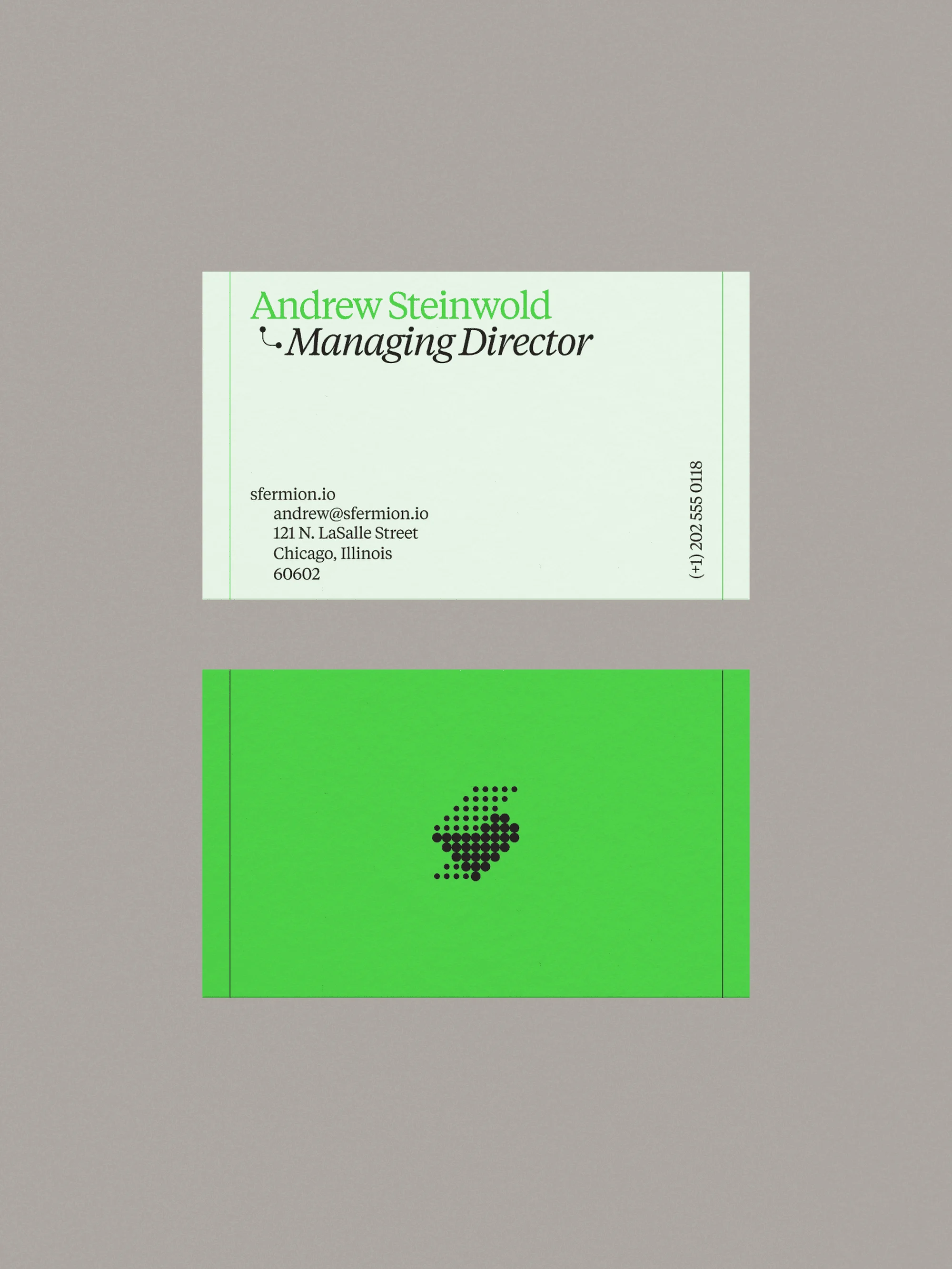 Two business cards, one light green with contact information, the other bright green with a black, geometric design.