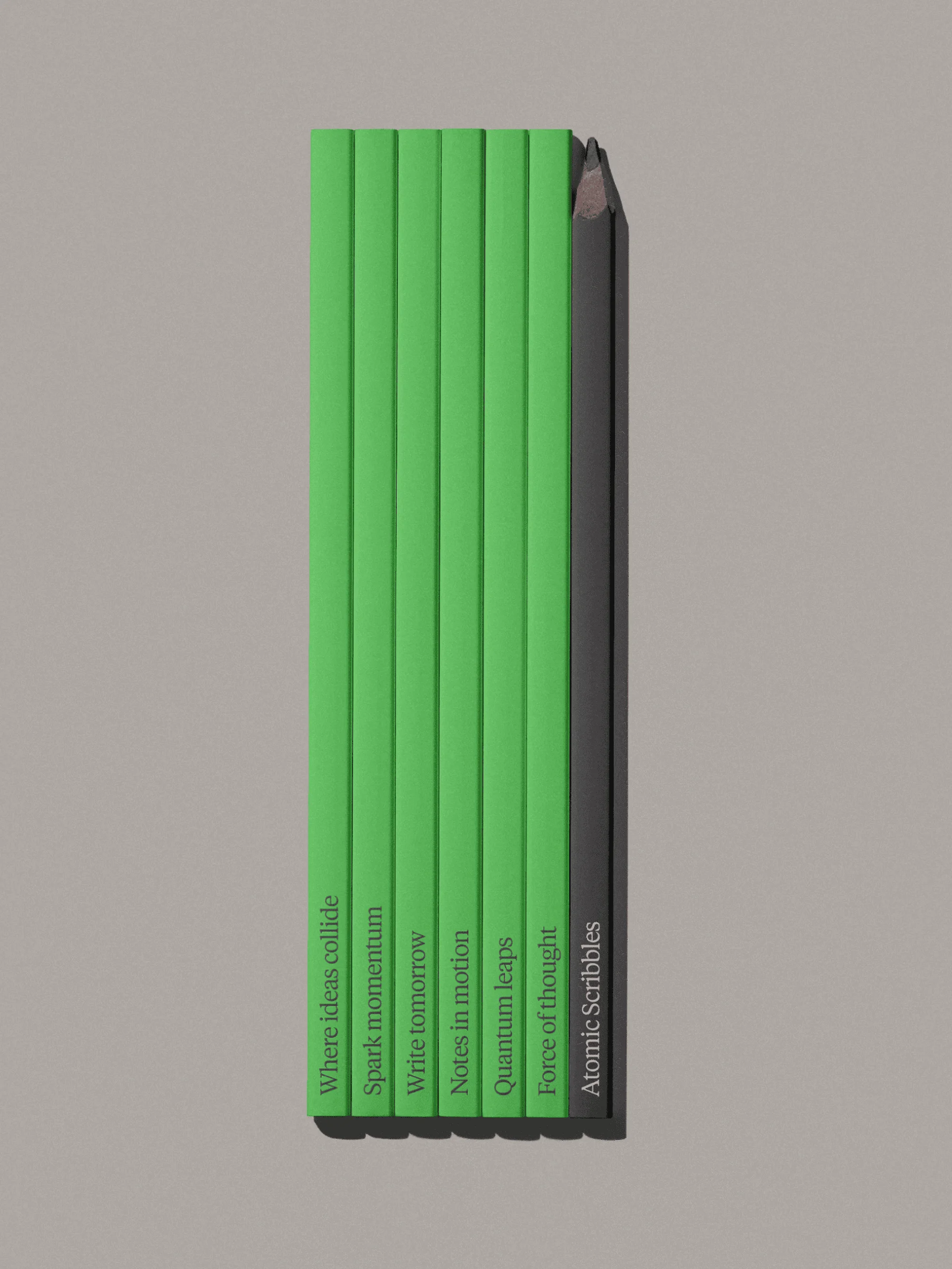 Stack of green notebooks with a dark pencil on a gray background, side view, studio shot with clear text on the notebook spines.