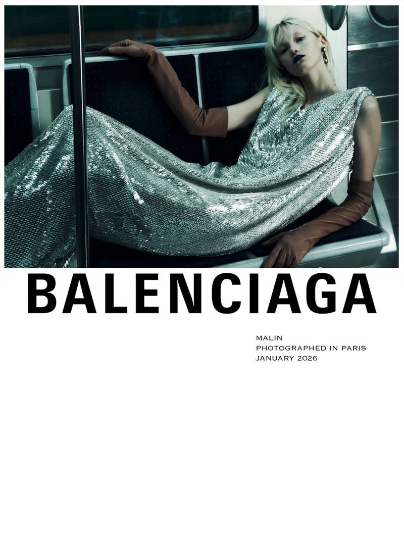 Fashion editorial shot of a woman in a silver sequin dress and brown gloves sitting in a subway, advertising Balenciaga.