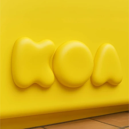 A yellow background features three rounded letters spelling out 'MOA,' with a minimalist aesthetic and even lighting creating a soft, modern look.