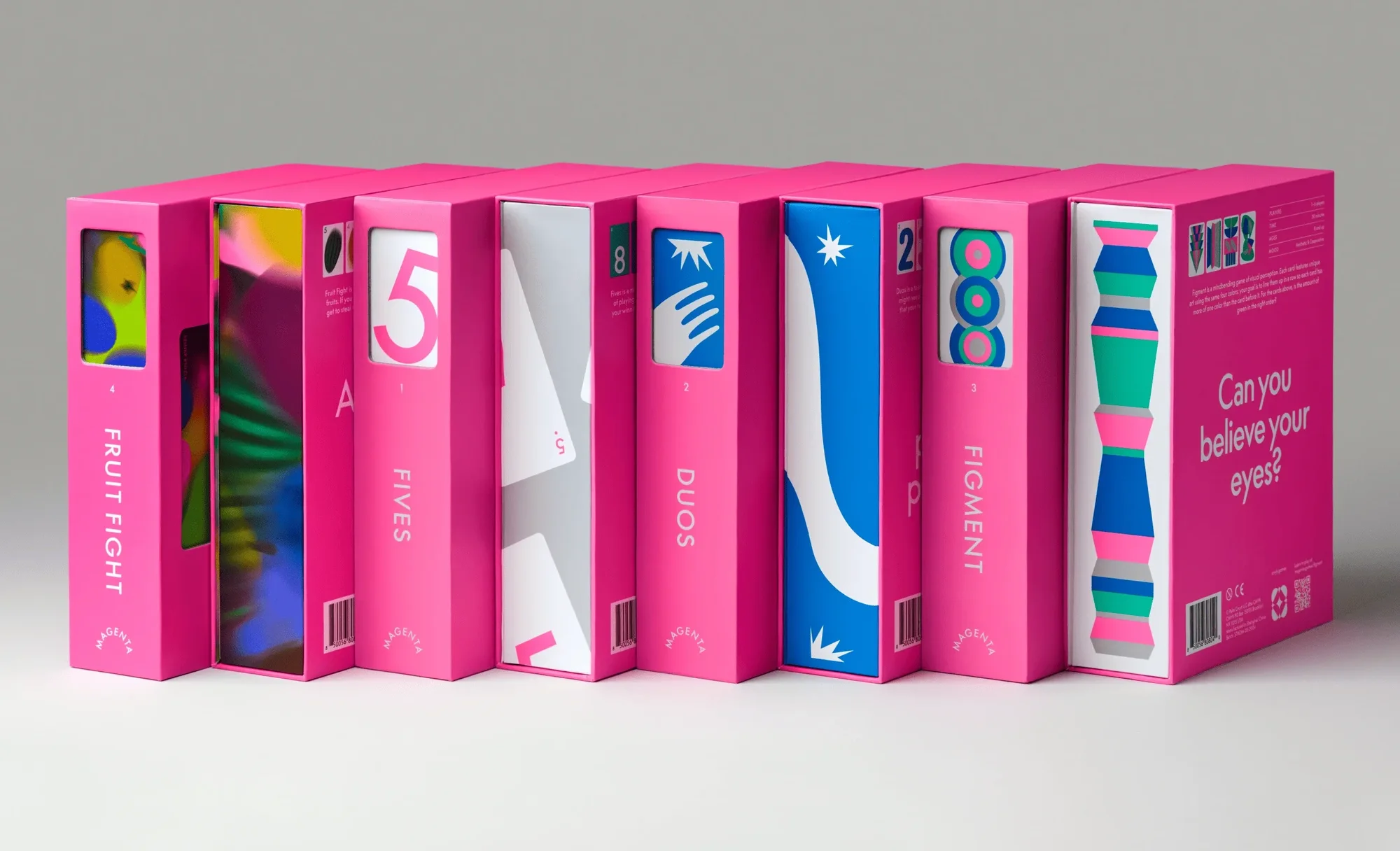 Arrangement of eight pink boxes with colorful graphic designs, stacked in a row on a white surface, studio lighting, product photography.