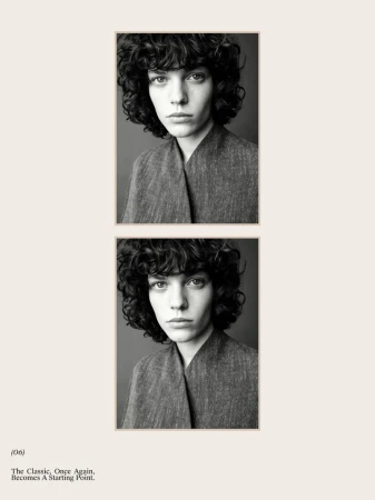 Black and white portrait of a young woman with curly hair and gray top, framed by a cream-colored border on a white background, fashion editorial.