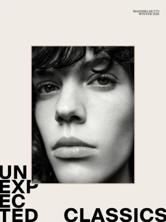 Black and white portrait of a young adult with wavy dark hair in a square frame, against a tan backdrop with text and a brand logo.