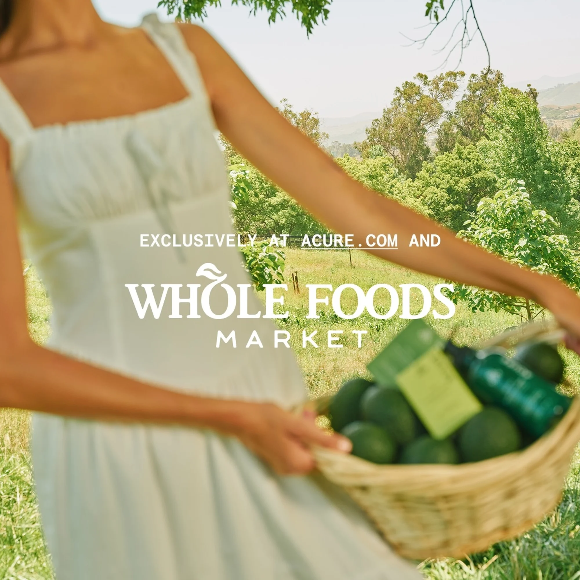 Adult female in a white dress carrying a basket of avocado and beauty products, outdoors with trees in the background.