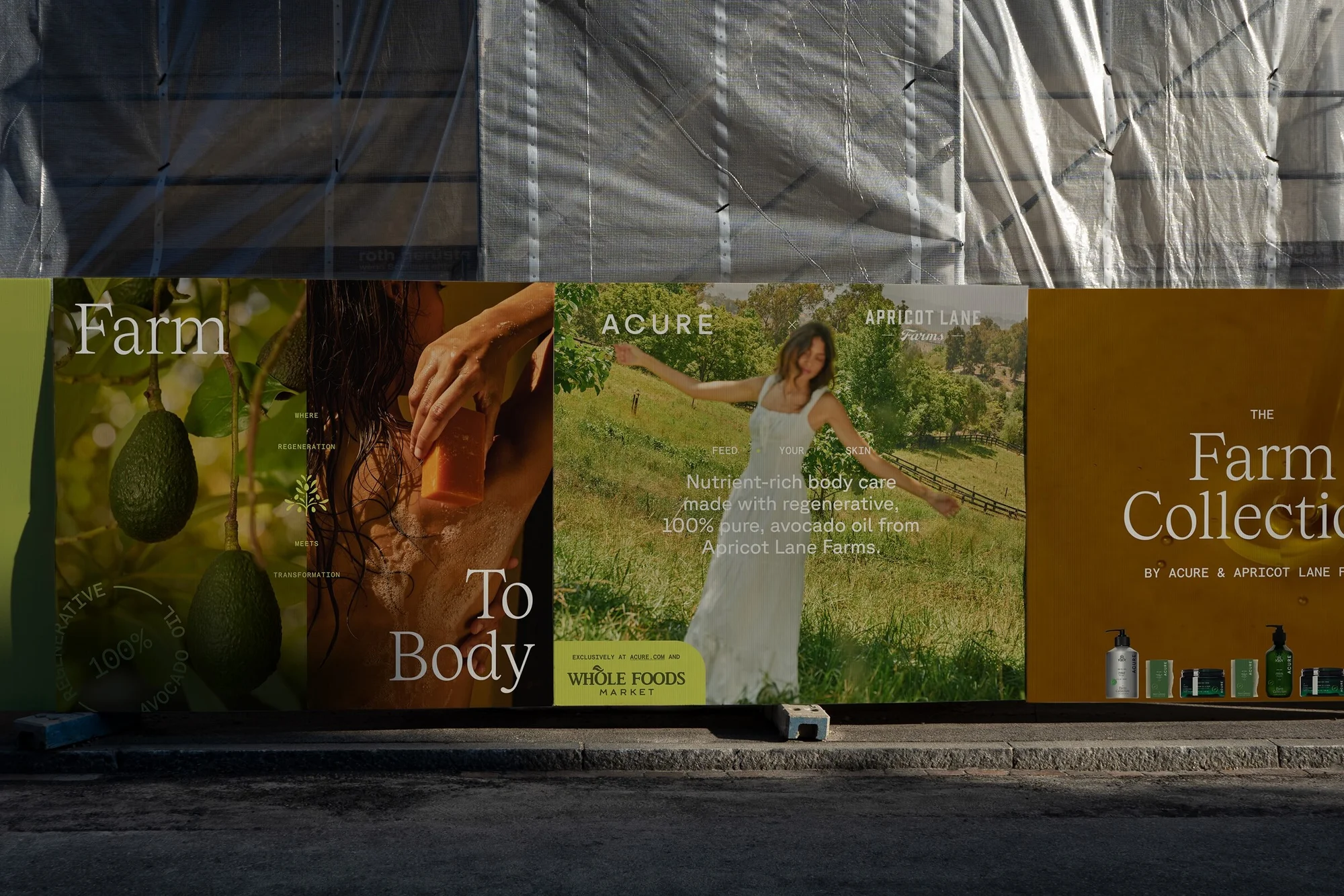 Advertisement display for Acure and Apricot Lane Farms features model, avocado, and skincare products against a blurred natural backdrop.
