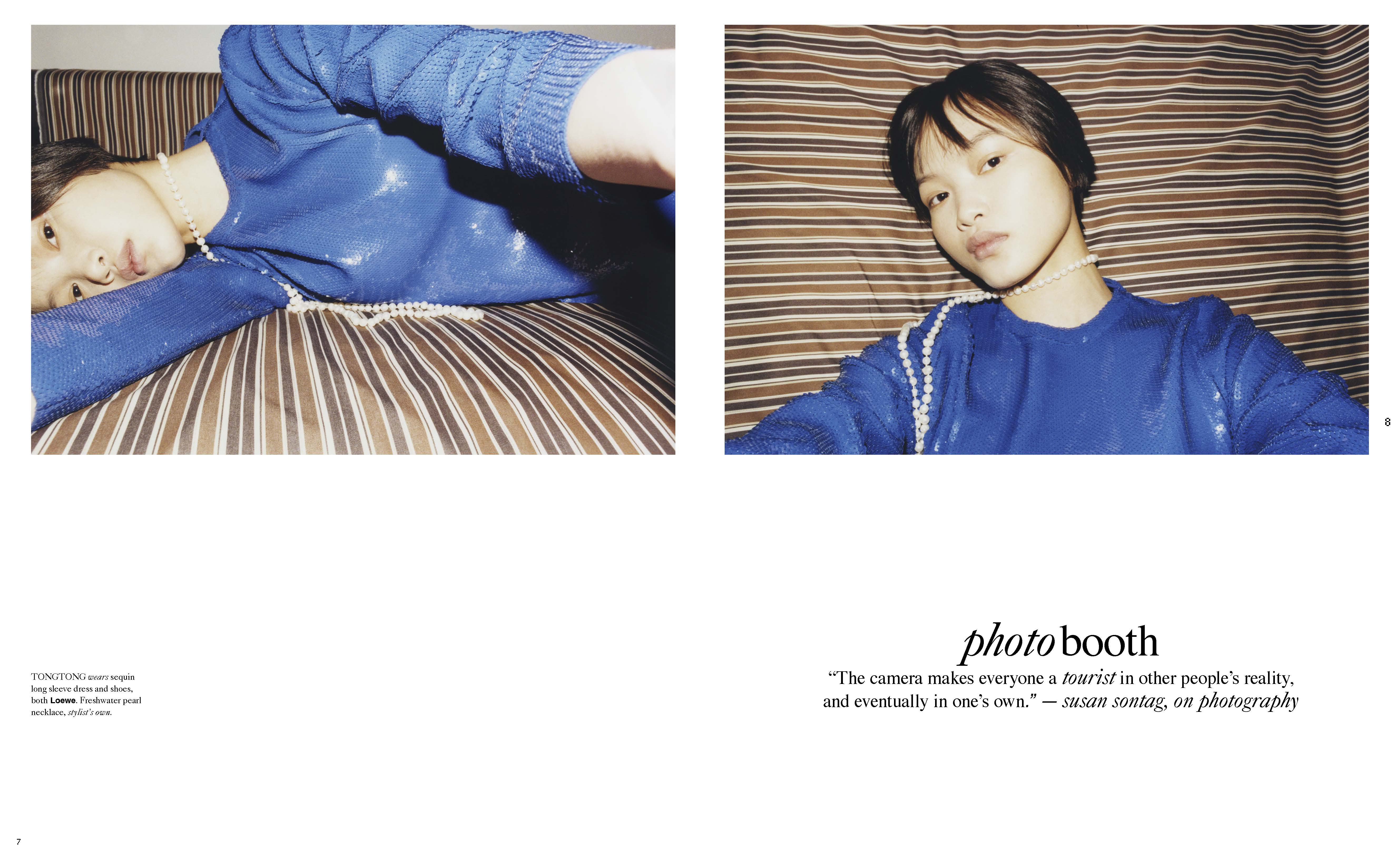 Woman in a blue sequined sweater and pearl necklace lies on a striped surface, captured in a fashion editorial style photograph.