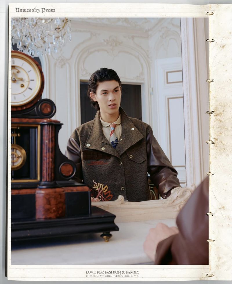 Young adult poses in a brown jacket in an ornate interior with a clock. Fashion editorial image for print with stylish clothing.