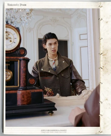 Young adult poses in a brown jacket in an ornate interior with a clock. Fashion editorial image for print with stylish clothing.
