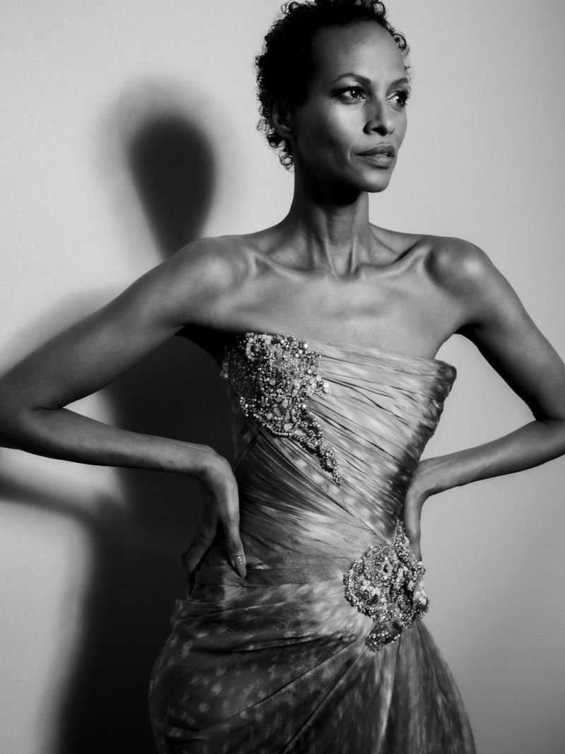 Elegant black and white portrait of a woman in a gown. The photograph showcases a short-haired female in formalwear.