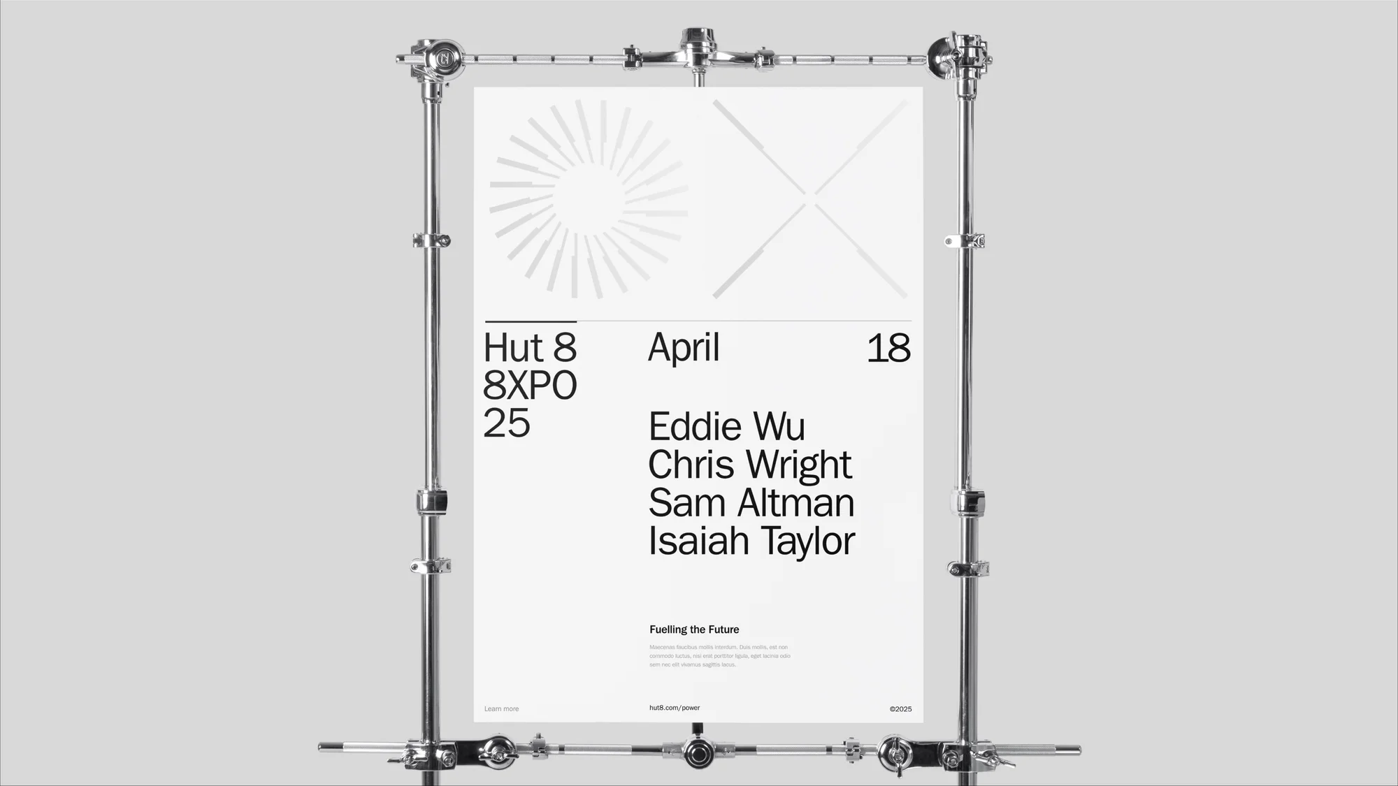 Promotional poster featuring text and geometric shapes held up by a metal stand against a light gray backdrop for a modern, minimalist effect.