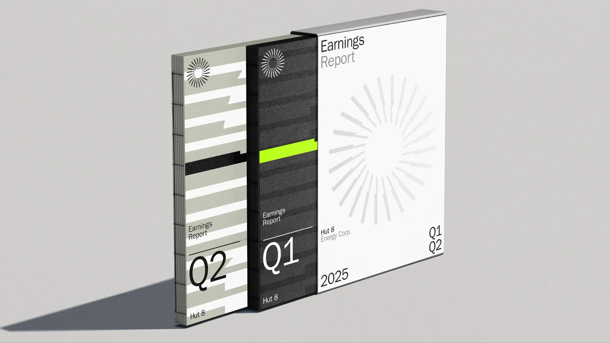 Three bound earnings report booklets with minimalist graphic covers resting against a plain grey surface with shadows