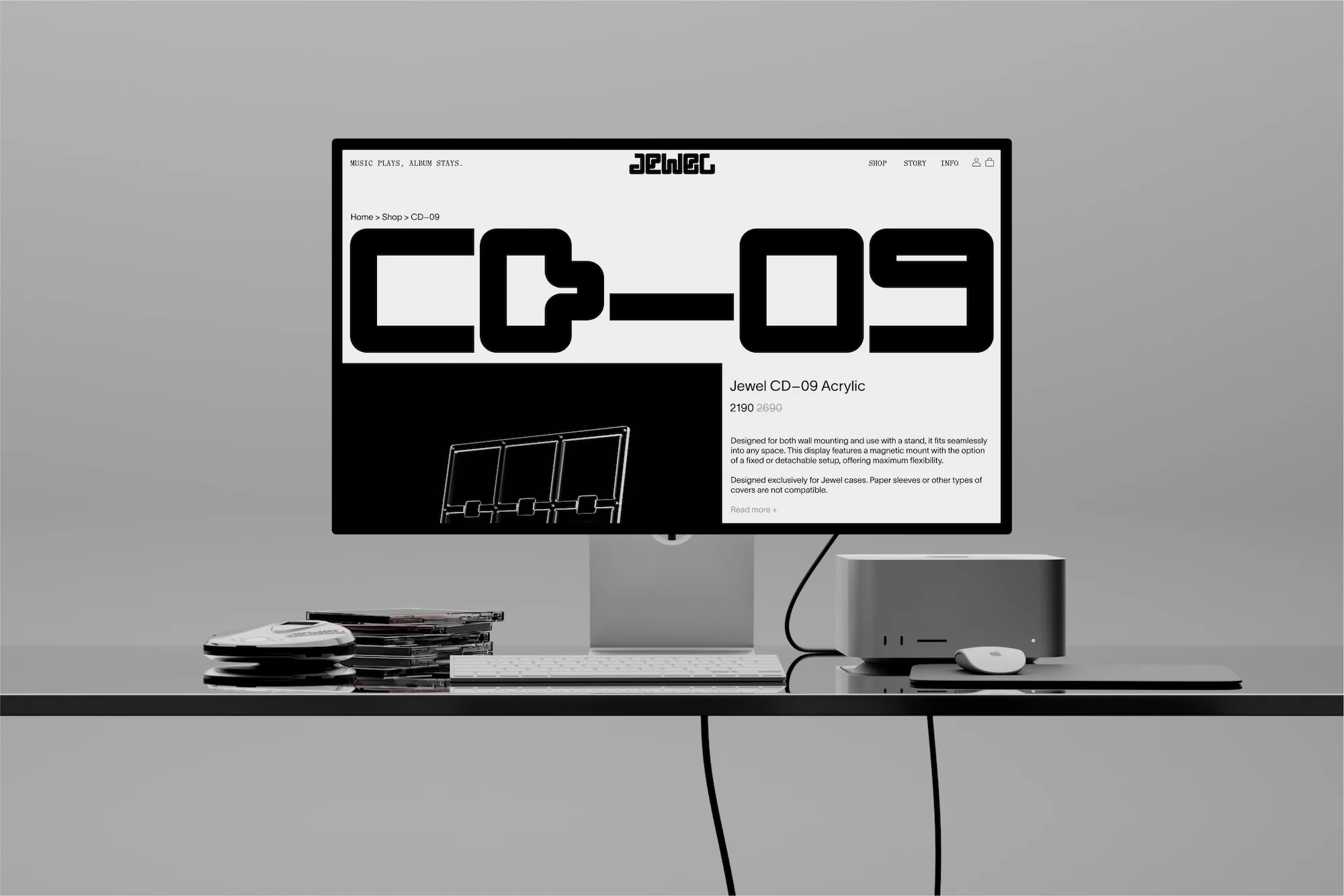 Product photography of a computer monitor displaying a website for Jewel CD-09 acrylic, set on a desk with a computer and CDs.