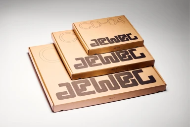 Three stacked brown cardboard boxes with custom typography and minimalist branding displayed on a white background