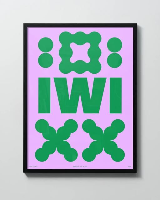 Graphic art print in a black frame on a white wall. The print features green geometric shapes on a purple background with the text 'IWI'.