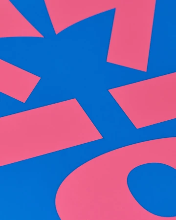 Abstract composition with pink geometric shapes on a vibrant blue background, creating a modern and minimalist design.