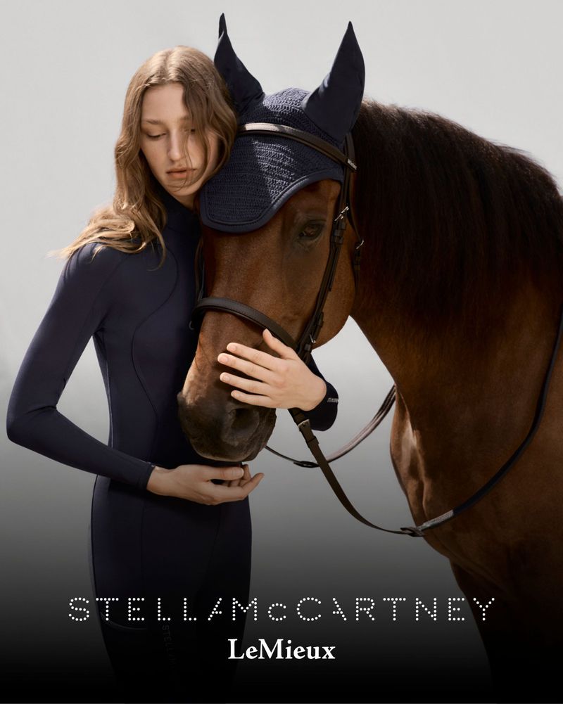 A woman in a navy dress embraces a chestnut-colored horse wearing a navy-blue ear bonnet, with text overlays of brand names.