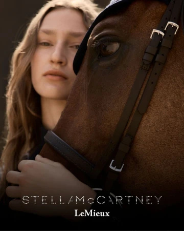 Close-up shot of a woman and a horse, showcasing a fashion collaboration between Stella McCartney and LeMieux, emphasizing equestrian style.