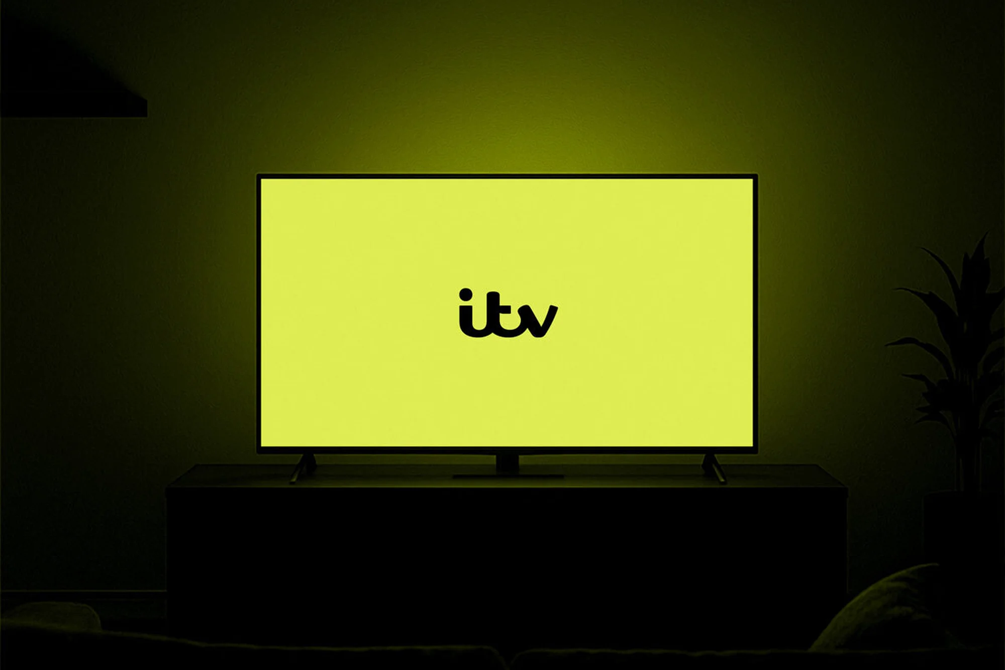 Illuminated television screen showing the ITV logo in a dark room with subtle plants, enhancing the entertainment experience.