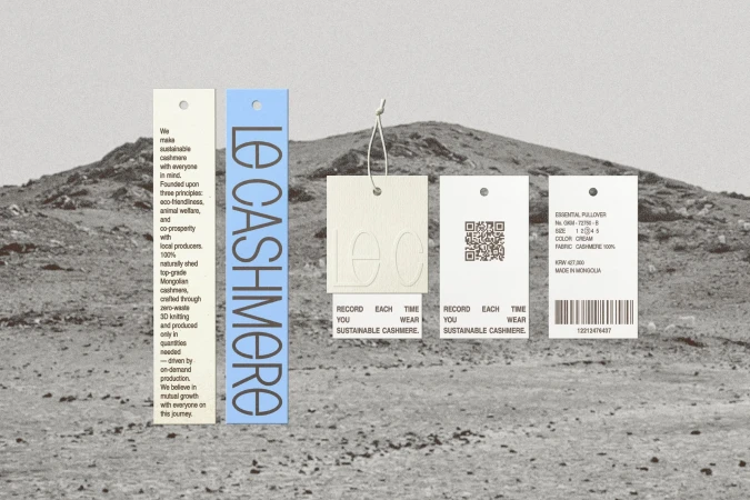 Promotional image showcasing multiple 'Le Cashmere' tags with product details against a desert landscape with a mountain range.