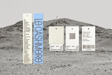 LE CASHMERE brand identity tags and labels displayed against a grainy mountain landscape background.
