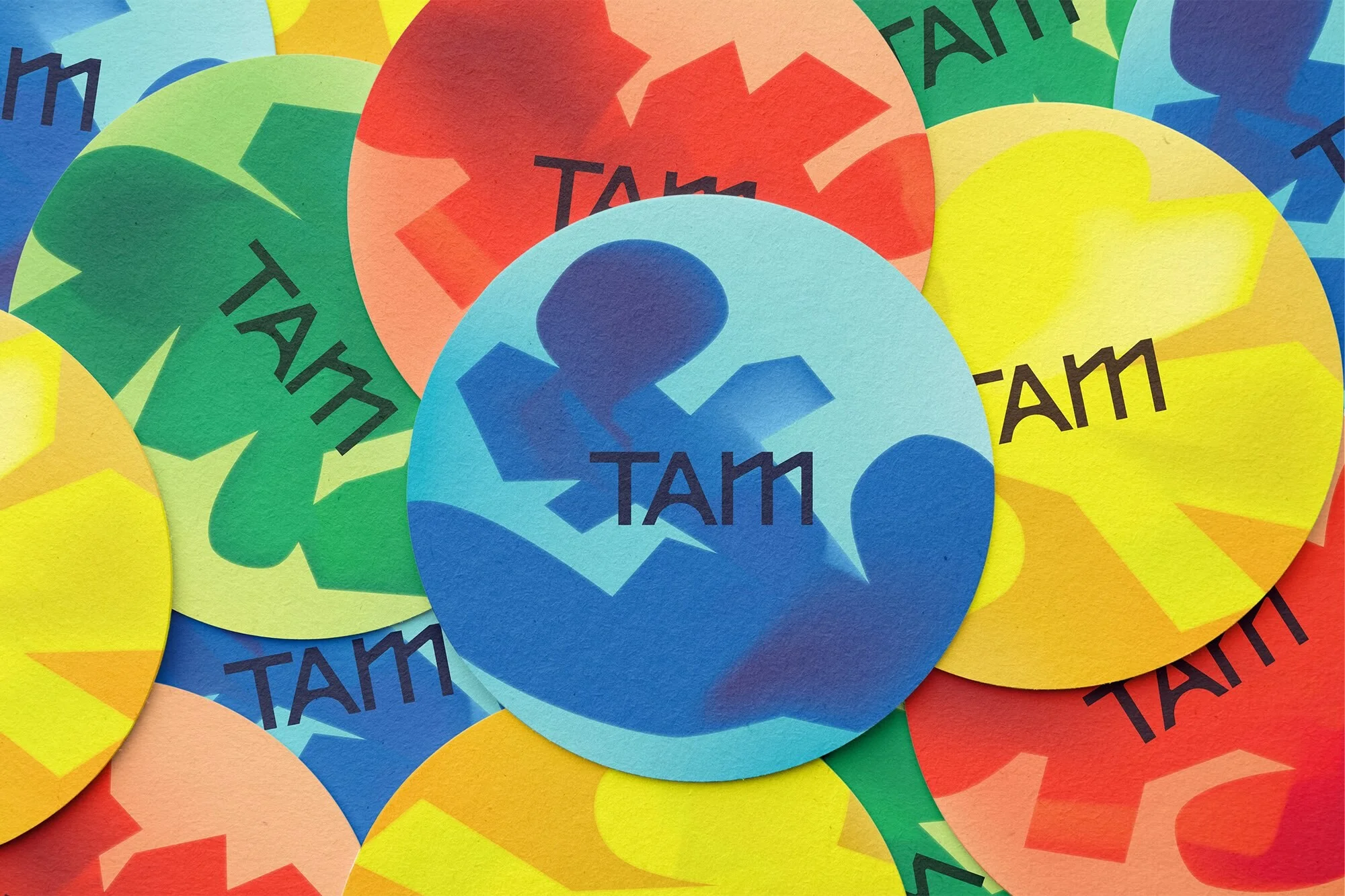 Overlapping colorful circles with abstract patterns and the word 'TAM' written on them create a vibrant and dynamic background.