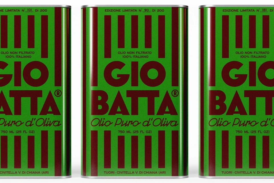 Three tins of Giobatta olive oil, with a green background and red vertical stripes, lined up in a studio product shot.