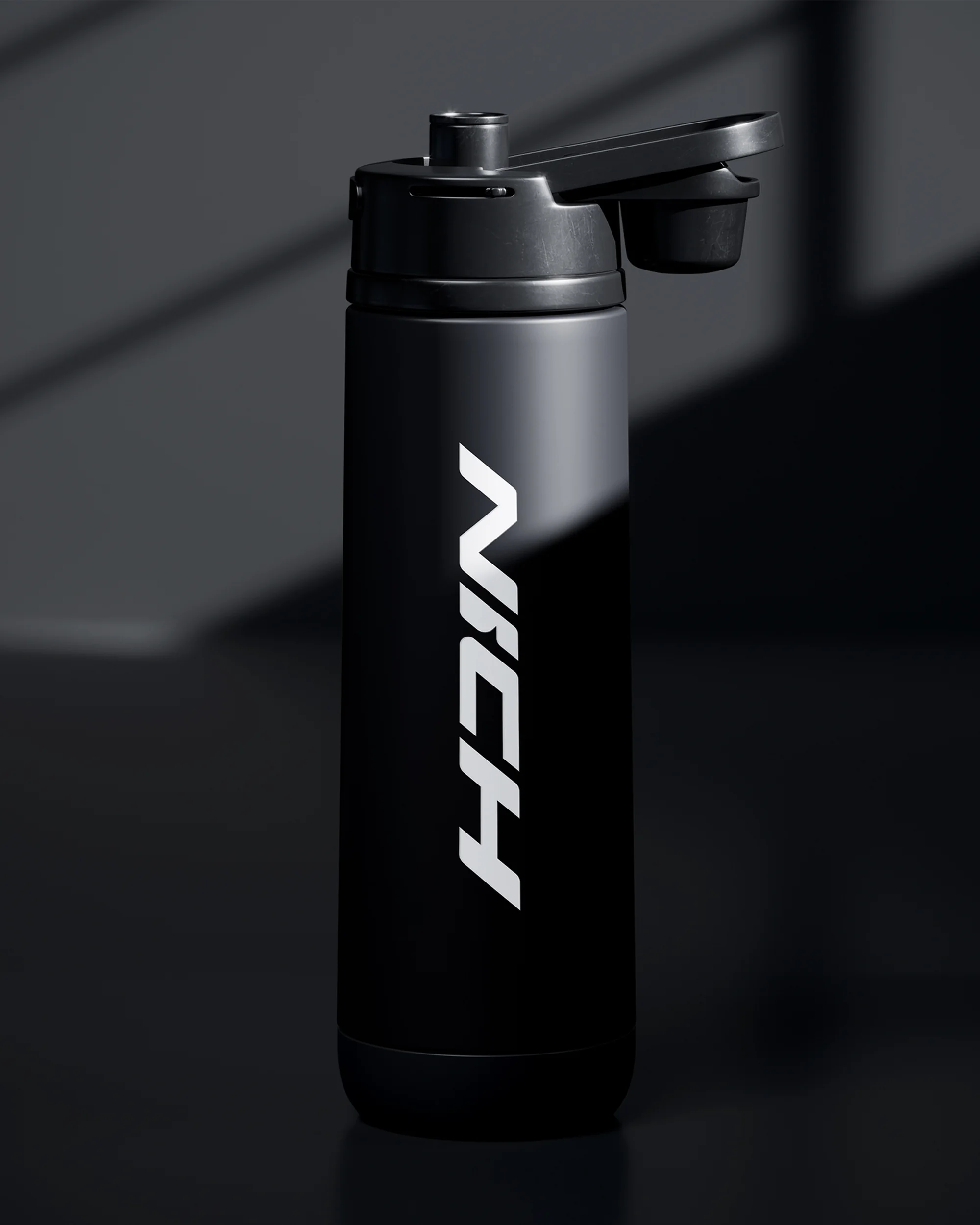 Black reusable water bottle with white logo on a dark gray background with light and shadow.