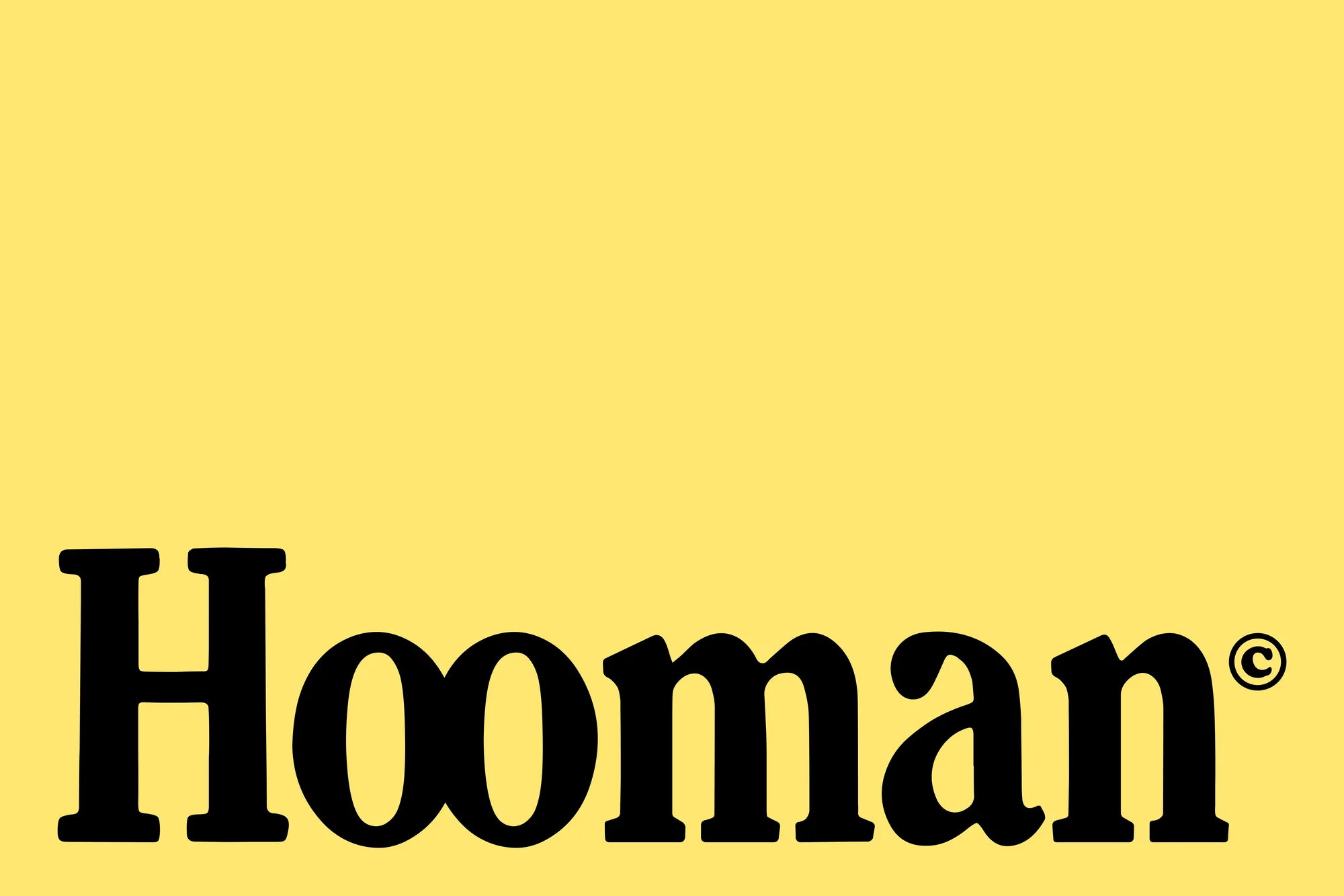 Text graphic on yellow background featuring the word 'Hooman' in bold, black letters with a copyright symbol next to the name.