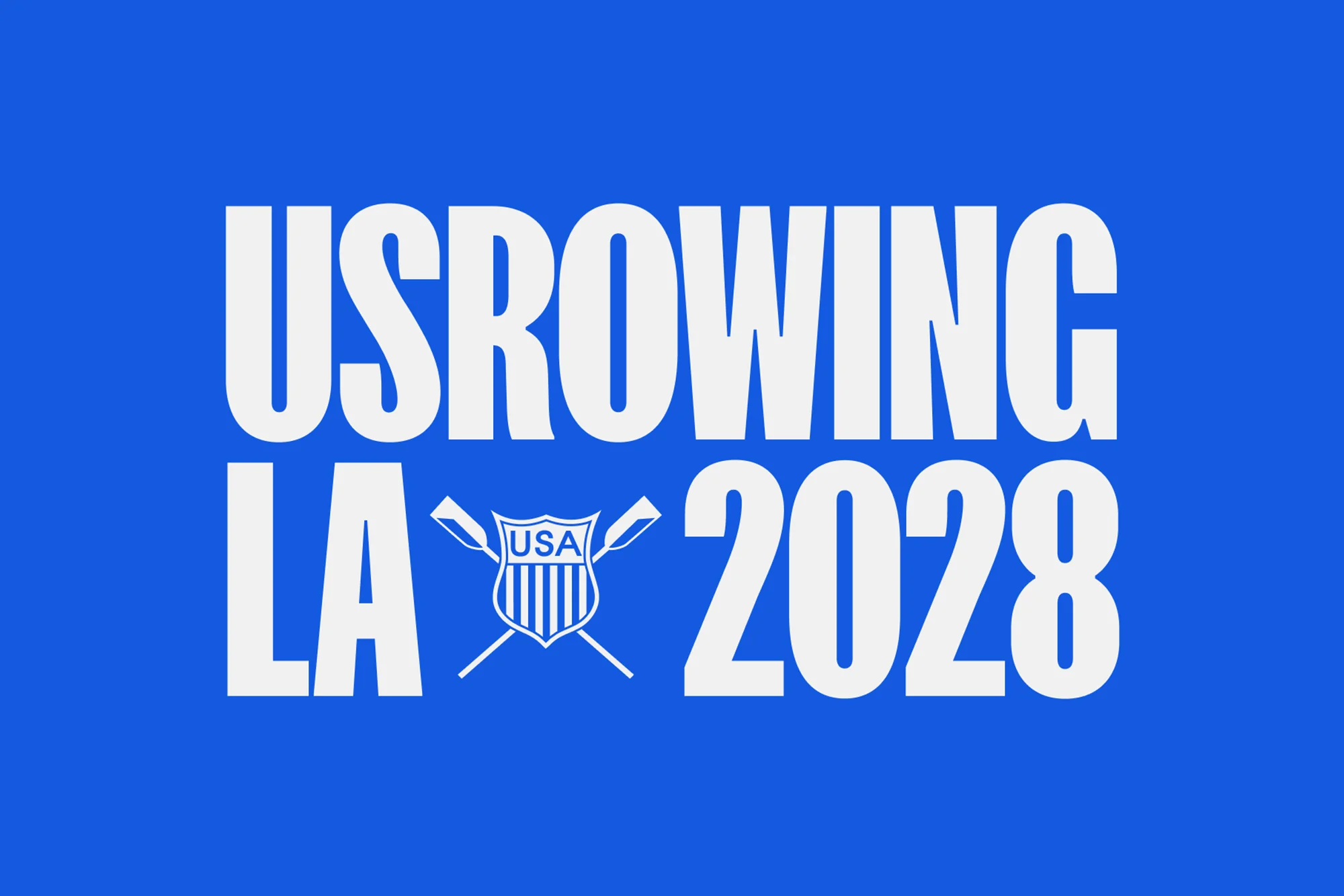USRowing LA 2028 logo on blue background with white text and shield symbol featuring crossed oars and USA lettering. 