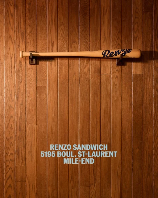 Baseball bat with 'Renzo' inscription mounted on a wooden wall with the text 'Renzo Sandwich' and address below.