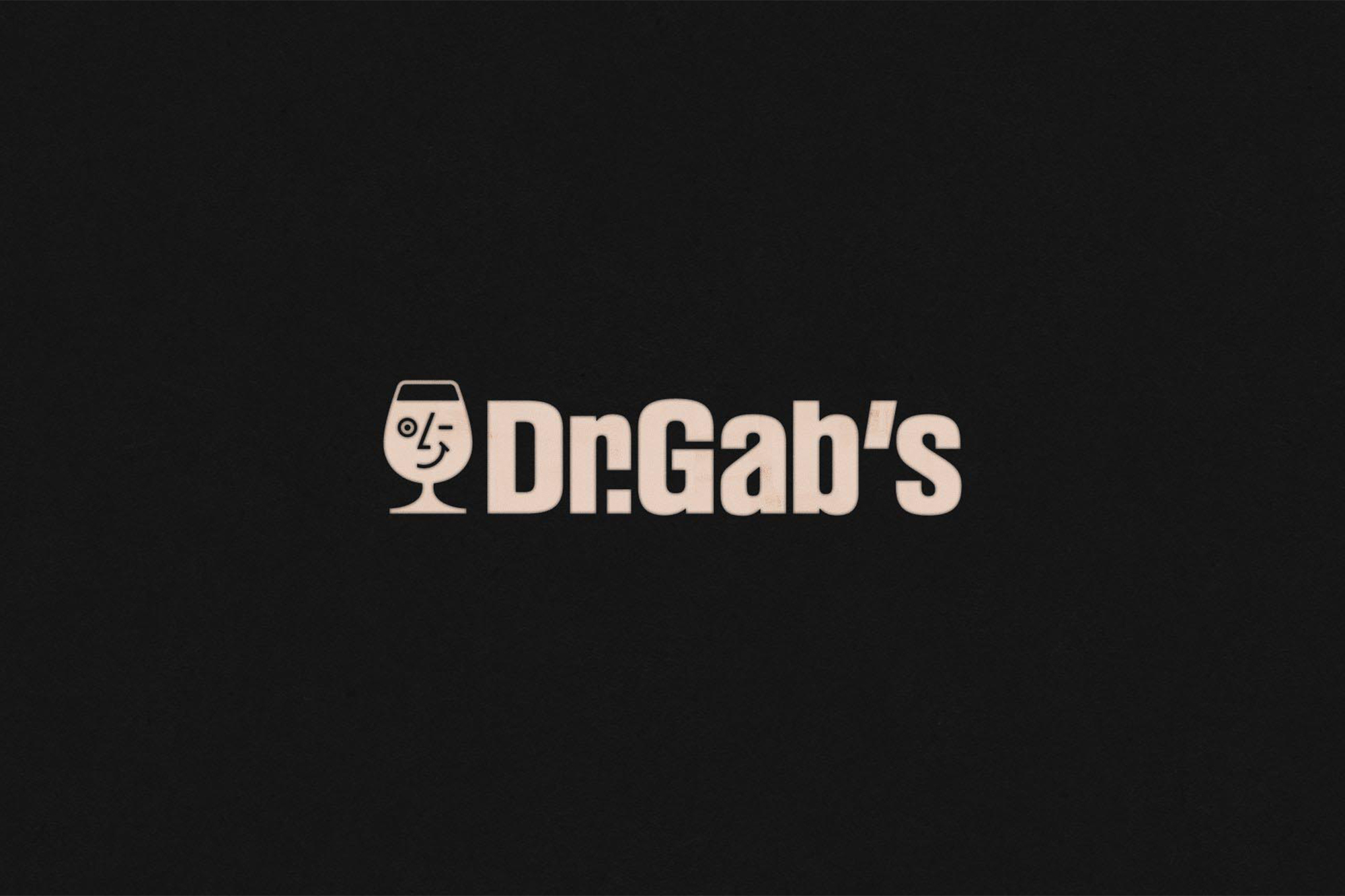 Dr. Gab's logo featuring a wine glass with a winking face on a black background, promoting the brand with a playful and inviting design.