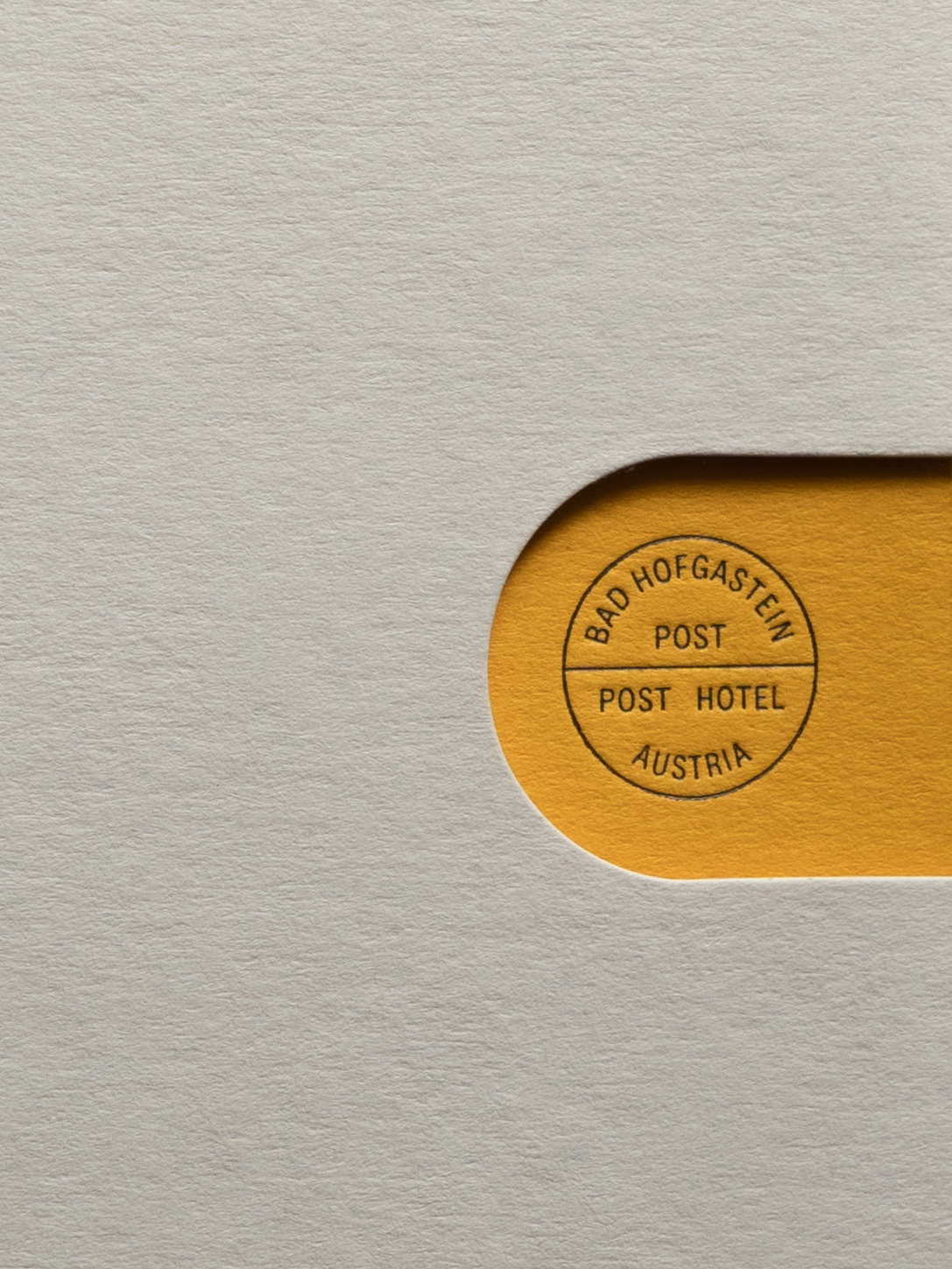 Tan-colored seal with dark lettering, 'Bad Hofgastein' on a white paper background. Vintage postal design with circular text.