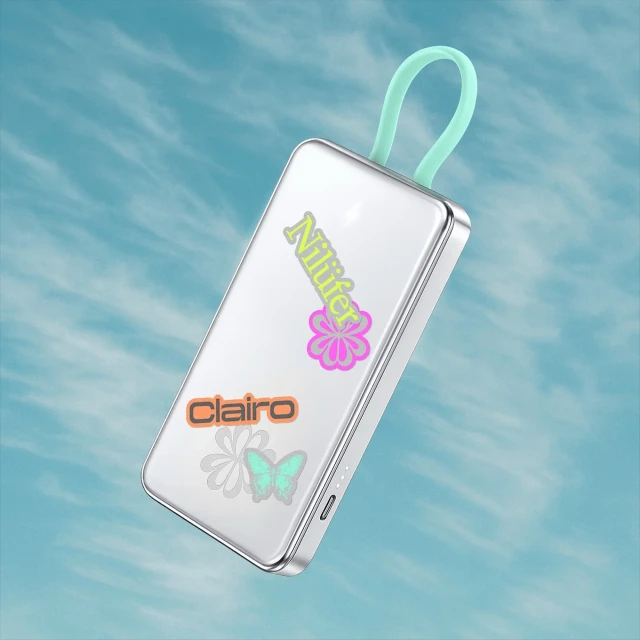 Floating portable charger with stickers in a blue sky. Decorative and functional for mobile power on the go, simple design.