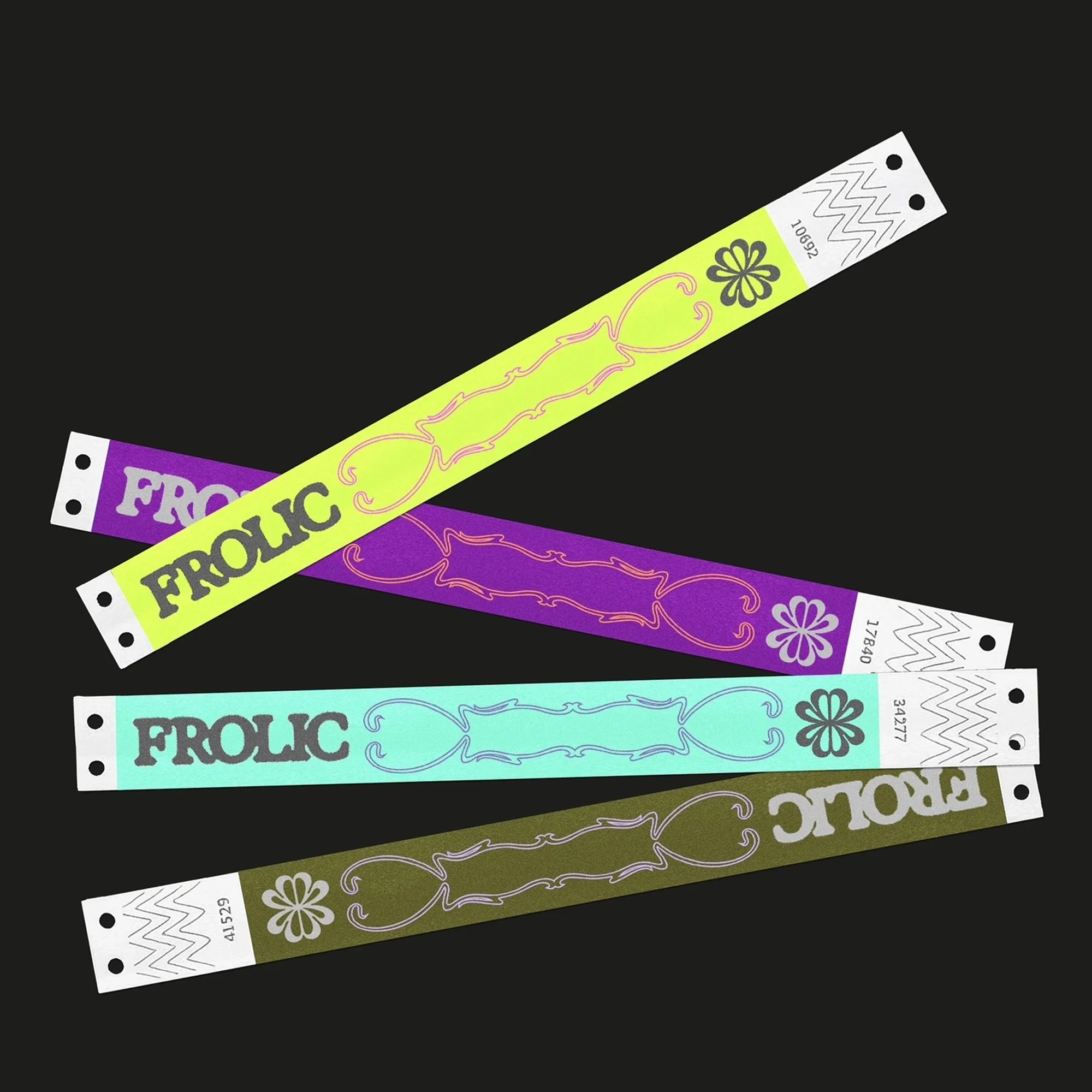 Colorful event wristbands stacked on a black background, each with unique designs and the word 'FROLIC' printed on them.
