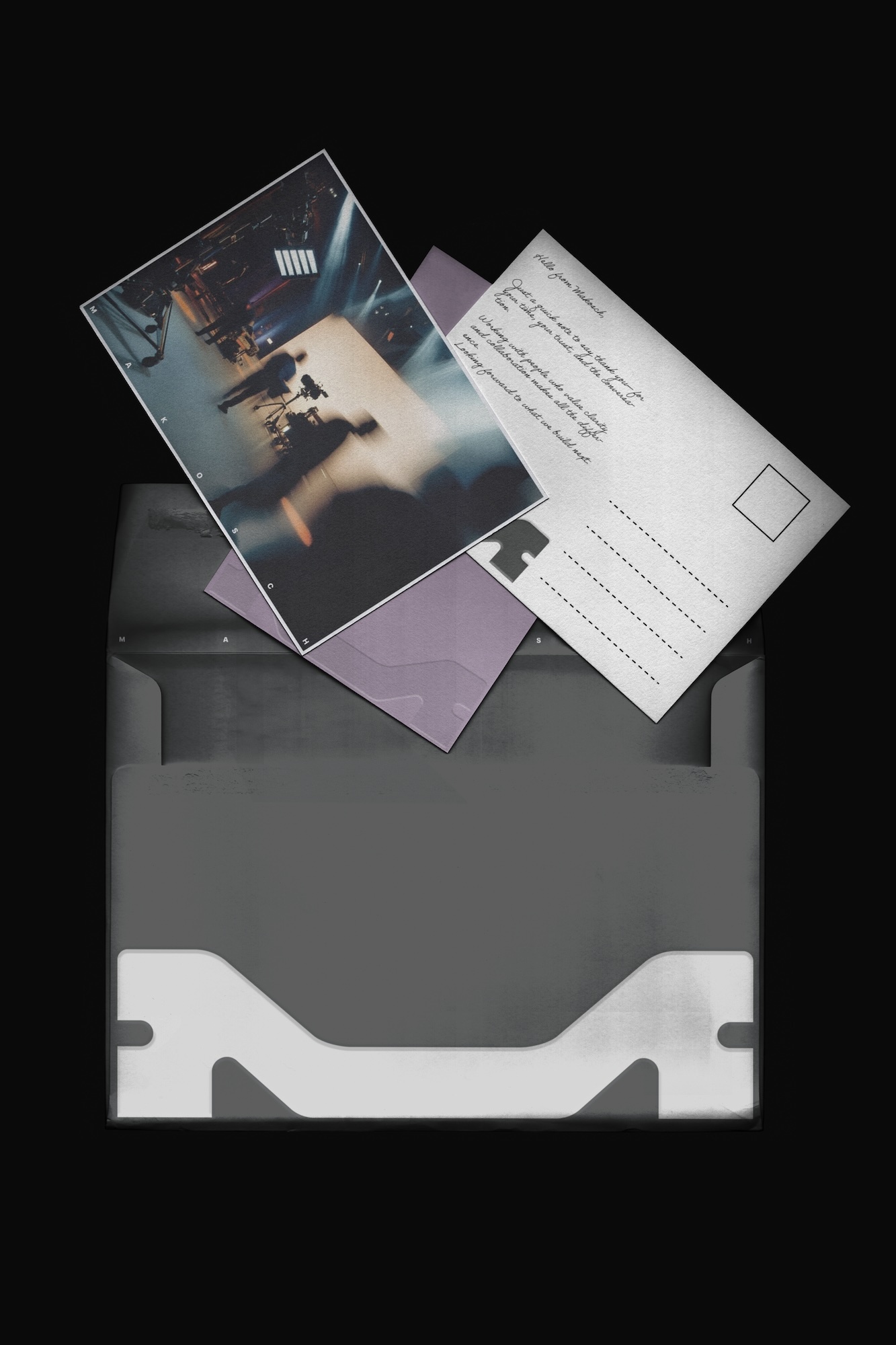Open grey envelope with visible postcards and a purple letter, set against a black background in a simple, graphic style.