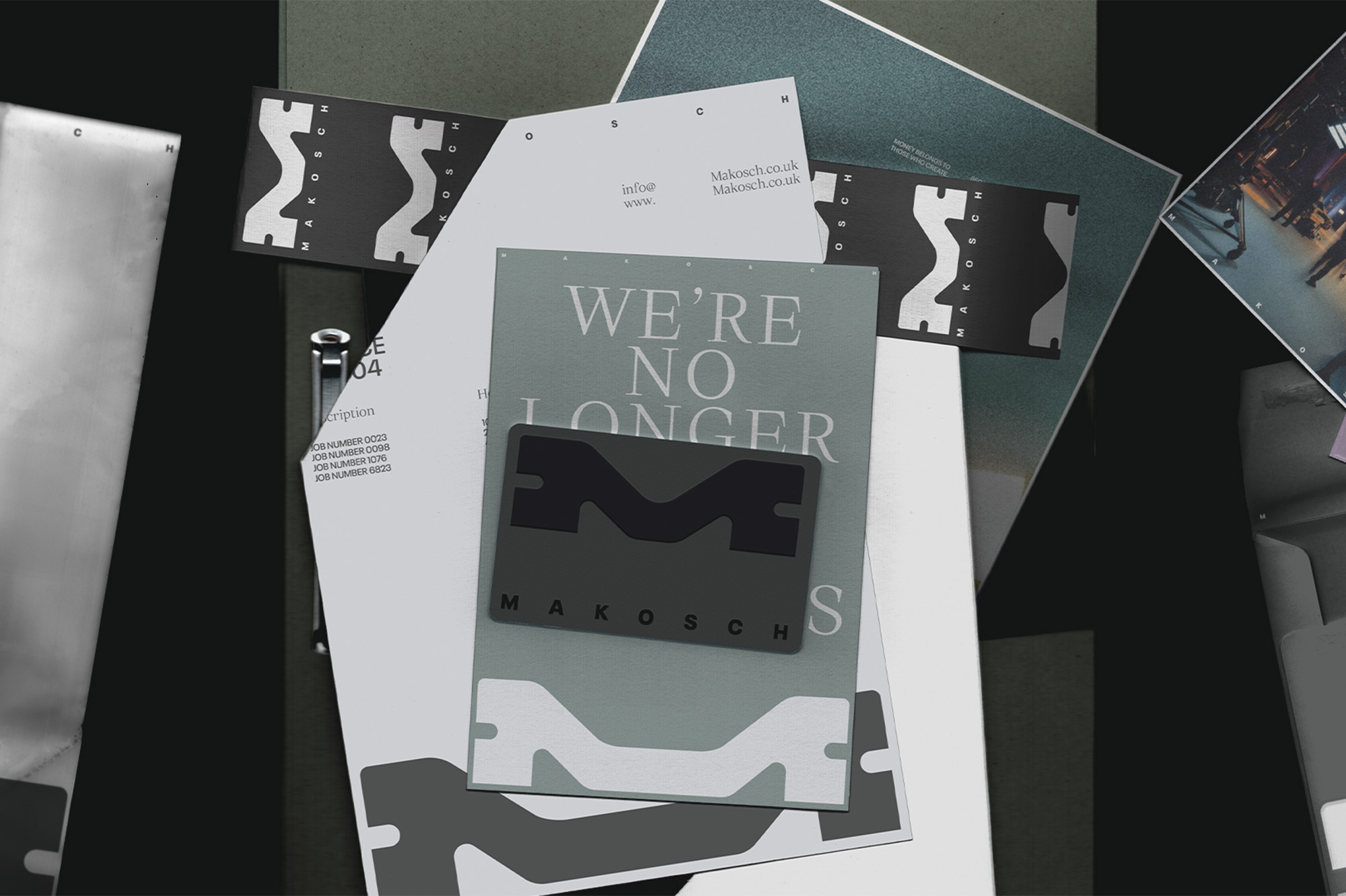 Abstract product presentation featuring Makosch-branded design, with business cards and graphic elements in grey tones on a dark background.