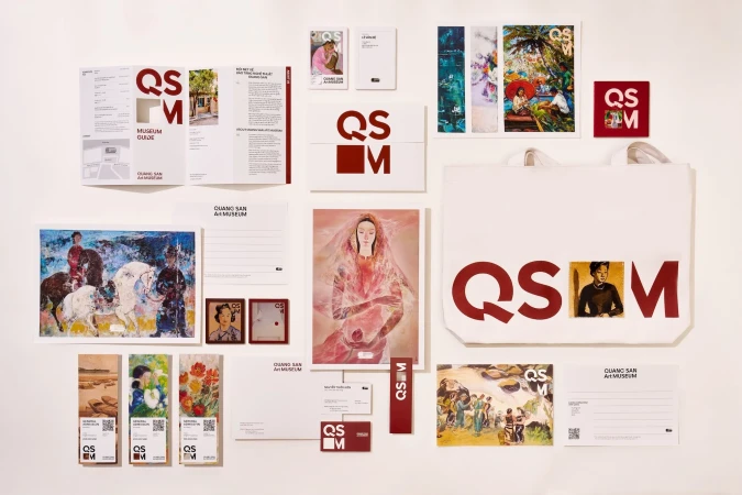 Promotional materials for Quang San Art Museum, including brochures, postcards, and a tote bag, arranged on a white surface.
