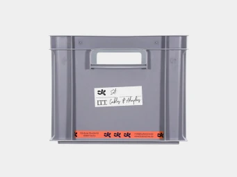 Grey plastic storage crate with a label reading Set: I.T.T. Cables & Adapters against a white background